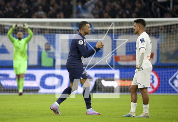 2023-02-26 - Kylian Mbappe of PSG celebrates his first goal while Cengiz Under of Marseille looks on during the French championship Ligue 1 football match between Olympique de Marseille (OM) and Paris Saint-Germain (PSG) on February 26, 2023 at Stade Velodrome in Marseille, France - FOOTBALL - FRENCH CHAMP - MARSEILLE V PARIS SG - FRENCH LIGUE 1 - SOCCER