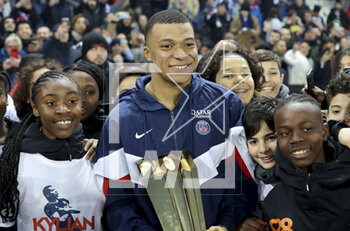 2023-03-05 - Kylian Mbappe of PSG receives a trophy celebrating his 201st goal for PSG, becoming the club's top scorer, during a ceremony following the French championship Ligue 1 football match between Paris Saint-Germain (PSG) and FC Nantes (FCN) on March 4, 2023 at Parc des Princes stadium in Paris, France - FOOTBALL - FRENCH CHAMP - PARIS SG V NANTES - FRENCH LIGUE 1 - SOCCER