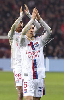 2023-03-10 - Maxence Caqueret, Bradley Barcola of Lyon salute the supporters of Lyon following the French championship Ligue 1 football match between Losc Lille and Olympique Lyonnais (Lyon) on March 10, 2023 at Pierre Mauroy stadium in Villeneuve-d'Ascq near Lille, France - FOOTBALL - FRENCH CHAMP - LILLE V LYON - FRENCH LIGUE 1 - SOCCER