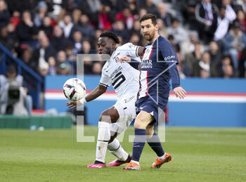 2023-03-19 - Lionel Messi of PSG, Arnaud Kalimuendo of Rennes (left) during the French championship Ligue 1 football match between Paris Saint-Germain and Stade Rennais (Rennes) on March 19, 2023 at Parc des Princes stadium in Paris, France - FOOTBALL - FRENCH CHAMP - PARIS SG V RENNES - FRENCH LIGUE 1 - SOCCER