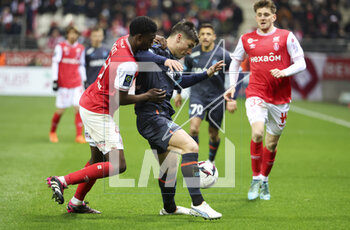2023-03-19 - Cheick Keita of Reims, Ruslan Malinovskyi of Marseille during the French championship Ligue 1 football match between Stade de Reims and Olympique de Marseille on March 19, 2023 at Auguste Delaune stadium in Reims, France - FOOTBALL - FRENCH CHAMP - REIMS V MARSEILLE - FRENCH LIGUE 1 - SOCCER