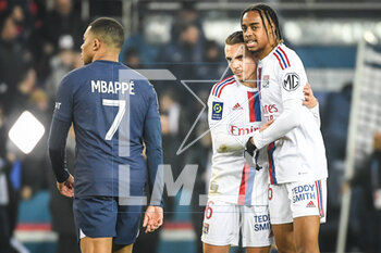 2023-04-02 - Kylian MBAPPE of PSG looks dejected and Maxence CAQUERET of Lyon and Bradley BARCOLA of Lyon celebrate the victory during the French championship Ligue 1 football match between Paris Saint-Germain and Olympique Lyonnais (Lyon) on April 2, 2023 at Parc des Princes stadium in Paris, France - FOOTBALL - FRENCH CHAMP - PARIS SG V LYON - FRENCH LIGUE 1 - SOCCER