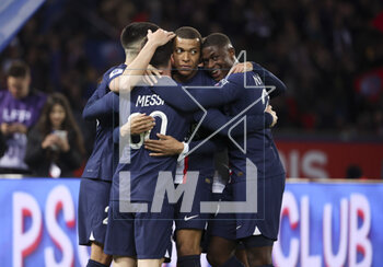 2023-04-15 - Kylian Mbappe, Nuno Mendes of PSG and teammates celebrate the goal of Lionel Messi #30 (left) during the French championship Ligue 1 football match between Paris Saint-Germain and RC Lens on April 15, 2023 at Parc des Princes stadium in Paris, France - FOOTBALL - FRENCH CHAMP - PARIS SG V LENS - FRENCH LIGUE 1 - SOCCER