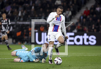 2023-04-21 - Kylian Mbappe of PSG scores his second goal despite Angers goalkeeper Paul Bernardoni during the French championship Ligue 1 football match between SCO Angers and Paris Saint-Germain (PSG) on April 21, 2023 at Stade Raymond Kopa in Angers, France - FOOTBALL - FRENCH CHAMP - ANGERS V PARIS SG - FRENCH LIGUE 1 - SOCCER