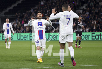 2023-04-21 - Kylian Mbappe of PSG celebrates his second goal with Lionel Messi (left) during the French championship Ligue 1 football match between SCO Angers and Paris Saint-Germain (PSG) on April 21, 2023 at Stade Raymond Kopa in Angers, France - FOOTBALL - FRENCH CHAMP - ANGERS V PARIS SG - FRENCH LIGUE 1 - SOCCER