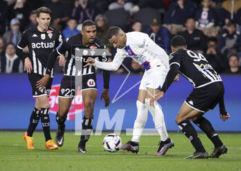 2023-04-21 - Kylian Mbappe of PSG, left Cedric Hountondji of Angers during the French championship Ligue 1 football match between SCO Angers and Paris Saint-Germain (PSG) on April 21, 2023 at Stade Raymond Kopa in Angers, France - FOOTBALL - FRENCH CHAMP - ANGERS V PARIS SG - FRENCH LIGUE 1 - SOCCER