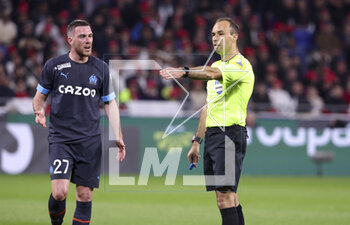 2023-04-23 - Referee Jerome Brisard, left Jordan Veretout of Marseille during the French championship Ligue 1 football match between Olympique Lyonnais (Lyon) and Olympique de Marseille on April 23, 2023 at Groupama stadium in Decines-Charpieu near Lyon, France - FOOTBALL - FRENCH CHAMP - LYON V MARSEILLE - FRENCH LIGUE 1 - SOCCER