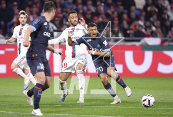 2023-04-23 - Corentin Tolisso of Lyon, Alexis Sanchez of Marseille during the French championship Ligue 1 football match between Olympique Lyonnais (Lyon) and Olympique de Marseille on April 23, 2023 at Groupama stadium in Decines-Charpieu near Lyon, France - FOOTBALL - FRENCH CHAMP - LYON V MARSEILLE - FRENCH LIGUE 1 - SOCCER
