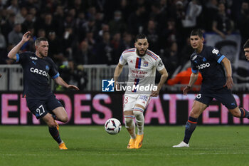 2023-04-23 - Rayan CHERKI of Lyon and Jordan VERETOUT of Marseille and Ruslan MALINOVSKYI of Marseille during the French championship Ligue 1 football match between Olympique Lyonnais (Lyon) and Olympique de Marseille on April 23, 2023 at Groupama stadium in Decines-Charpieu near Lyon, France - FOOTBALL - FRENCH CHAMP - LYON V MARSEILLE - FRENCH LIGUE 1 - SOCCER