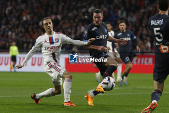 2023-04-23 - Jordan VERETOUT of Marseille and Maxence CAQUERET of Lyon during the French championship Ligue 1 football match between Olympique Lyonnais (Lyon) and Olympique de Marseille on April 23, 2023 at Groupama stadium in Decines-Charpieu near Lyon, France - FOOTBALL - FRENCH CHAMP - LYON V MARSEILLE - FRENCH LIGUE 1 - SOCCER