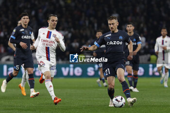 2023-04-23 - Valentin RONGIER of Marseille and Maxence CAQUERET of Lyon during the French championship Ligue 1 football match between Olympique Lyonnais (Lyon) and Olympique de Marseille on April 23, 2023 at Groupama stadium in Decines-Charpieu near Lyon, France - FOOTBALL - FRENCH CHAMP - LYON V MARSEILLE - FRENCH LIGUE 1 - SOCCER