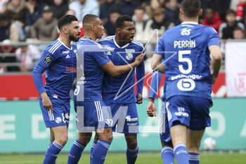 2023-04-23 - Habib Diallo of Strasbourg celebrates his first goal with Morgan Sanson, Alexander Djiku (left) during the French championship Ligue 1 football match between Stade de Reims and RC Strasbourg on April 23, 2023 at Stade Auguste Delaune in Reims, France - FOOTBALL - FRENCH CHAMP - REIMS V STRASBOURG - FRENCH LIGUE 1 - SOCCER