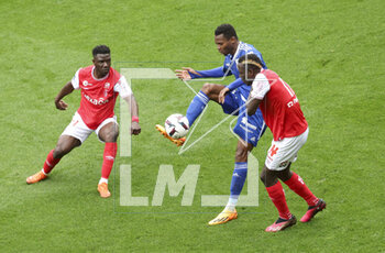 2023-04-23 - Habib Diallo of Strasbourg between Azor Matusiwa, Dion Lopy of Reims during the French championship Ligue 1 football match between Stade de Reims and RC Strasbourg on April 23, 2023 at Stade Auguste Delaune in Reims, France - FOOTBALL - FRENCH CHAMP - REIMS V STRASBOURG - FRENCH LIGUE 1 - SOCCER