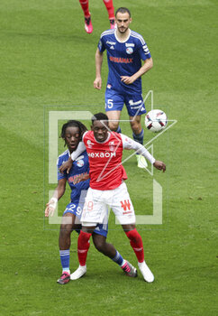 2023-04-23 - Ismael Doukoure of Strasbourg, Folarin Balogun of Reims during the French championship Ligue 1 football match between Stade de Reims and RC Strasbourg on April 23, 2023 at Stade Auguste Delaune in Reims, France - FOOTBALL - FRENCH CHAMP - REIMS V STRASBOURG - FRENCH LIGUE 1 - SOCCER