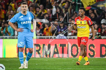 2023-05-06 - Lois OPENDA of Lens celebrates his goal and Valentin RONGIER of Marseille looks dejected during the French championship Ligue 1 football match between RC Lens and Olympique de Marseille on May 6, 2023 at Bollaert-Delelis stadium in Lens, France - FOOTBALL - FRENCH CHAMP - LENS V MARSEILLE - FRENCH LIGUE 1 - SOCCER