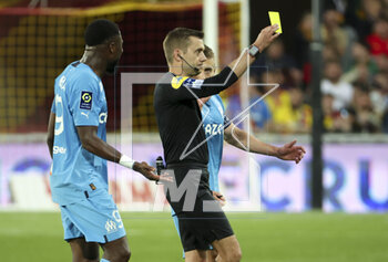 2023-05-06 - Referee Clement Turpin gives a yellow card during the French championship Ligue 1 football match between RC Lens (RCL) and Olympique de Marseille (OM) on May 6, 2023 at Stade Bollaert-Delelis in Lens, France - FOOTBALL - FRENCH CHAMP - LENS V MARSEILLE - FRENCH LIGUE 1 - SOCCER