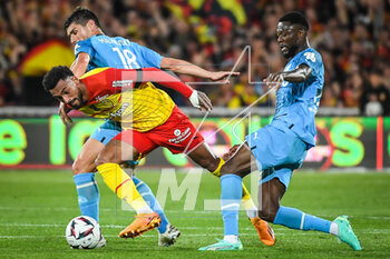 2023-05-06 - Lois OPENDA of Lens, Ruslan MALINOVSKYI of Marseille and Chancel MBEMBA of Marseille during the French championship Ligue 1 football match between RC Lens and Olympique de Marseille on May 6, 2023 at Bollaert-Delelis stadium in Lens, France - FOOTBALL - FRENCH CHAMP - LENS V MARSEILLE - FRENCH LIGUE 1 - SOCCER