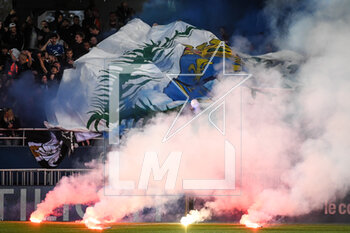 2023-05-07 - Troyes supporters throw smoke bombs on the pitch during the French championship Ligue 1 football match between Estac Troyes and Paris Saint-Germain on May 7, 2023 at l'Aube stadium in Troyes, France - FOOTBALL - FRENCH CHAMP - TROYES V PARIS SG - FRENCH LIGUE 1 - SOCCER