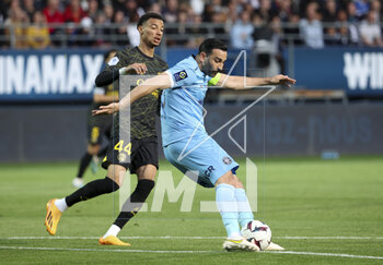 2023-05-07 - Adil Rami of Troyes, left Hugo Ekitike of PSG during the French championship Ligue 1 football match between Estac Troyes and Paris Saint-Germain on May 7, 2023 at l'Aube stadium in Troyes, France - FOOTBALL - FRENCH CHAMP - TROYES V PARIS SG - FRENCH LIGUE 1 - SOCCER