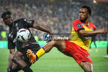 2023-05-12 - Emmanuel AGBADOU of Reims and Lois OPENDA of Lens during the French championship Ligue 1 football match between RC Lens and Stade de Reims on May 12, 2023 at Bollaert-Delelis stadium in Lens, France - FOOTBALL - FRENCH CHAMP - LENS V REIMS - FRENCH LIGUE 1 - SOCCER