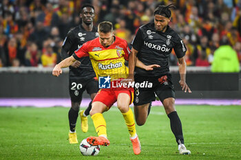 2023-05-12 - Folarin BALOGUN of Reims, Przemyslaw Adam FRANKOWSKI of Lens and Jens CAJUSTE of Reims during the French championship Ligue 1 football match between RC Lens and Stade de Reims on May 12, 2023 at Bollaert-Delelis stadium in Lens, France - FOOTBALL - FRENCH CHAMP - LENS V REIMS - FRENCH LIGUE 1 - SOCCER