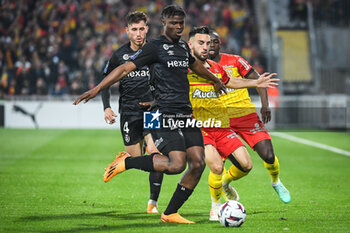 2023-05-12 - Maxime BUSI of Reims, Emmanuel AGBADOU of Reims and Adrien THOMASSON of Lens during the French championship Ligue 1 football match between RC Lens and Stade de Reims on May 12, 2023 at Bollaert-Delelis stadium in Lens, France - FOOTBALL - FRENCH CHAMP - LENS V REIMS - FRENCH LIGUE 1 - SOCCER