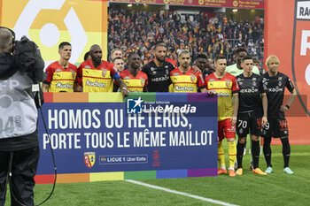 2023-05-12 - Both teams together behind a banner supporting gay rights before the French championship Ligue 1 football match between RC Lens and Stade de Reims on May 12, 2023 at Stade Bollaert-Delelis in Lens, France - FOOTBALL - FRENCH CHAMP - LENS V REIMS - FRENCH LIGUE 1 - SOCCER