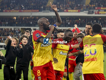 2023-05-12 - Captain Seko Fofana of Lens holding the mic celebrates the victory with teammates following the French championship Ligue 1 football match between RC Lens and Stade de Reims on May 12, 2023 at Stade Bollaert-Delelis in Lens, France - FOOTBALL - FRENCH CHAMP - LENS V REIMS - FRENCH LIGUE 1 - SOCCER