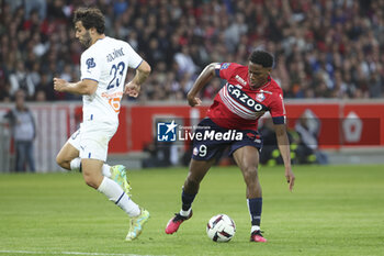 2023-05-20 - Jonathan David of Lille, left Sead Kolasinac of Marseille during the French championship Ligue 1 Uber Eats football match between Lille OSC (LOSC) and Olympique de Marseille (OM) on May 20, 2023 at Stade Pierre Mauroy in Villeneuve-d'Ascq near Lille, France - FOOTBALL - FRENCH CHAMP - LILLE V MARSEILLE - FRENCH LIGUE 1 - SOCCER