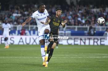 2023-05-21 - Isaak Toure of Auxerre, Hugo Ekitike of PSG during the French championship Ligue 1 football match between AJ Auxerre (AJA) and Paris Saint-Germain (PSG) on May 21, 2023 at Abbé-Deschamps stadium in Auxerre, France - FOOTBALL - FRENCH CHAMP - AUXERRE V PARIS SG - FRENCH LIGUE 1 - SOCCER