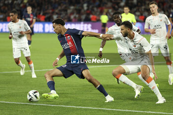 2023-08-13 - Hugo Ekitike of PSG, Montassar Talbi of Lorient during the French championship Ligue 1 football match between Paris Saint-Germain (PSG) and FC Lorient on August 12, 2023 at Parc des Princes stadium in Paris, France - FOOTBALL - FRENCH CHAMP - PARIS SG V LORIENT - FRENCH LIGUE 1 - SOCCER