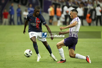 2023-08-20 - Ousmane Dembele of PSG, Gabriel Suazo of Toulouse during the French championship Ligue 1 football match between Toulouse FC and Paris Saint-Germain on August 19, 2023 at Stadium in Toulouse, France - FOOTBALL - FRENCH CHAMP - TOULOUSE V PARIS SG - FRENCH LIGUE 1 - SOCCER