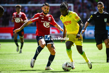 2023-08-20 - Remy CABELLA of Lille and Moses SIMON of Nantes during the French championship Ligue 1 football match between LOSC Lille and FC Nantes on August 20, 2023 at Pierre Mauroy stadium in Villeneuve-d'Ascq near Lille, France - FOOTBALL - FRENCH CHAMP - LILLE V NANTES - FRENCH LIGUE 1 - SOCCER