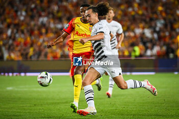 2023-08-20 - Morgan GUILAVOGUI of Lens and Arthur THEATE of Rennes during the French championship Ligue 1 football match between RC Lens and Stade Rennais (Rennes) on August 20, 2023 at Bollaert-Delelis stadium in Lens, France - FOOTBALL - FRENCH CHAMP - LENS V RENNES - FRENCH LIGUE 1 - SOCCER