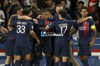 2023-08-27 - Kylian Mbappe of PSG celebrates his first goal with teammates during the French championship Ligue 1 football match between Paris Saint-Germain (PSG) and RC Lens (RCL) on August 26, 2023 at Parc des Princes stadium in Paris, France - FOOTBALL - FRENCH CHAMP - PARIS SG V LENS - FRENCH LIGUE 1 - SOCCER