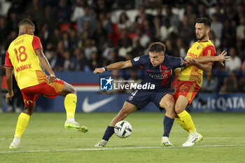 2023-08-27 - Manuel Ugarte of PSG, Adrien Thomasson of Lens during the French championship Ligue 1 football match between Paris Saint-Germain (PSG) and RC Lens (RCL) on August 26, 2023 at Parc des Princes stadium in Paris, France - FOOTBALL - FRENCH CHAMP - PARIS SG V LENS - FRENCH LIGUE 1 - SOCCER
