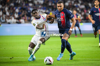 2023-09-03 - Ernest NUAMAH of Lyon and Kylian MBAPPE of PSG during the French championship Ligue 1 football match between Olympique Lyonnais (Lyon) and Paris Saint-Germain on September 3, 2023 at Groupama stadium in Decines-Charpieu near Lyon, France - FOOTBALL - FRENCH CHAMP - LYON V PARIS SG - FRENCH LIGUE 1 - SOCCER