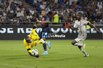 2023-09-03 - Kylian Mbappe of PSG against Lyon goalkeeper Anthony Lopes and Clinton Mata of Lyon during the French championship Ligue 1 football match between Olympique Lyonnais (Lyon, OL) and Paris Saint-Germain (PSG) on September 3, 2023 at Groupama stadium in Decines-Charpieu near Lyon, France - FOOTBALL - FRENCH CHAMP - LYON V PARIS SG - FRENCH LIGUE 1 - SOCCER