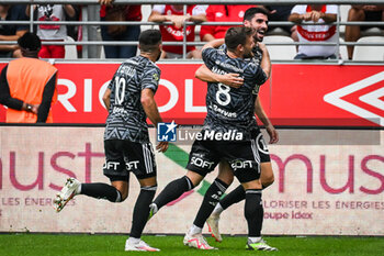 2023-09-17 - Pierre LEES-MELOU of Brest celebrate his goal with teammates during the French championship Ligue 1 football match between Stade De Reims and Stade Brestois on September 17, 2023 at Auguste Delaune stadium in Reims, France - FOOTBALL - FRENCH CHAMP - REIMS V BREST - FRENCH LIGUE 1 - SOCCER