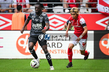 2023-09-17 - Bradley LOCKO of Brest and Junya ITO of Reims during the French championship Ligue 1 football match between Stade De Reims and Stade Brestois on September 17, 2023 at Auguste Delaune stadium in Reims, France - FOOTBALL - FRENCH CHAMP - REIMS V BREST - FRENCH LIGUE 1 - SOCCER