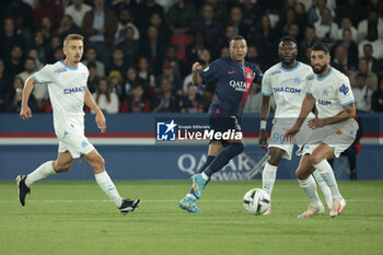 2023-09-24 - Kylian Mbappe of PSG between Valentin Rongier, Chancel Mbemba, Samuel Gigot of Marseille during the French championship Ligue 1 football match between Paris Saint-Germain and Olympique de Marseille on September 24, 2023 at Parc des Princes stadium in Paris, France - FOOTBALL - FRENCH CHAMP - PARIS SG V MARSEILLE - FRENCH LIGUE 1 - SOCCER