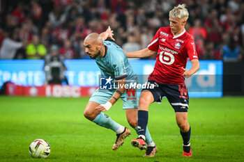 2023-09-26 - Teddy TEUMA of Reims and Hakon ARNAR HARALDSSON of Lille during the French championship Ligue 1 football match between LOSC Lille and Stade de Reims on September 26, 2023 at Pierre Mauroy stadium in Villeneuve-d'Ascq near Lille, France - FOOTBALL - FRENCH CHAMP - LILLE V REIMS - FRENCH LIGUE 1 - SOCCER