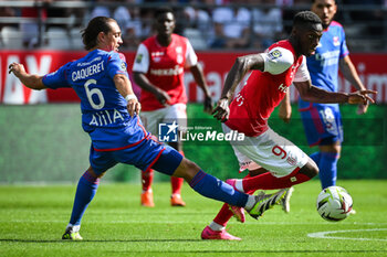 2023-10-01 - Maxence CAQUERET of Lyon and Mohamed DARAMY of Reims during the French championship Ligue 1 football match between Stade de Reims and Olympique Lyonnais on October 1, 2023 at Auguste Delaune stadium in Reims, France - FOOTBALL - FRENCH CHAMP - REIMS V LYON - FRENCH LIGUE 1 - SOCCER