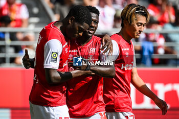 2023-10-01 - Marshall MUNETSI of Reims celebrate his goa with Azor MATUSIWA of Reims and Keito NAKAMURA of Reims during the French championship Ligue 1 football match between Stade de Reims and Olympique Lyonnais on October 1, 2023 at Auguste Delaune stadium in Reims, France - FOOTBALL - FRENCH CHAMP - REIMS V LYON - FRENCH LIGUE 1 - SOCCER