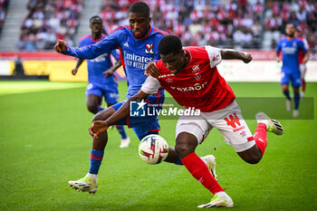 2023-10-01 - Clinton MATA of Lyon and Marshall MUNETSI of Reims during the French championship Ligue 1 football match between Stade de Reims and Olympique Lyonnais on October 1, 2023 at Auguste Delaune stadium in Reims, France - FOOTBALL - FRENCH CHAMP - REIMS V LYON - FRENCH LIGUE 1 - SOCCER