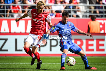 2023-10-01 - Junya ITO of Reims and Nicolas TAGLIAFICO of Lyon during the French championship Ligue 1 football match between Stade de Reims and Olympique Lyonnais on October 1, 2023 at Auguste Delaune stadium in Reims, France - FOOTBALL - FRENCH CHAMP - REIMS V LYON - FRENCH LIGUE 1 - SOCCER