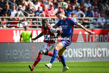2023-10-01 - Mohamed DARAMY of Reims and Jake O'BRIEN of Lyon during the French championship Ligue 1 football match between Stade de Reims and Olympique Lyonnais on October 1, 2023 at Auguste Delaune stadium in Reims, France - FOOTBALL - FRENCH CHAMP - REIMS V LYON - FRENCH LIGUE 1 - SOCCER