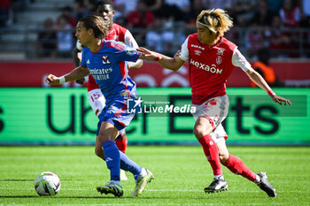 2023-10-01 - Maxence CAQUERET of Lyon and Junya ITO of Reims during the French championship Ligue 1 football match between Stade de Reims and Olympique Lyonnais on October 1, 2023 at Auguste Delaune stadium in Reims, France - FOOTBALL - FRENCH CHAMP - REIMS V LYON - FRENCH LIGUE 1 - SOCCER