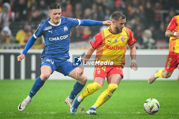 2023-11-12 - Vitor OLIVEIRA (Vitinha) of Marseille and Jonathan GRADIT of Lens during the French championship Ligue 1 football match between RC Lens and Olympique de Marseille on November 12, 2023 at Bollaert-Delelis stadium in Lens, France - FOOTBALL - FRENCH CHAMP - LENS V MARSEILLE - FRENCH LIGUE 1 - SOCCER