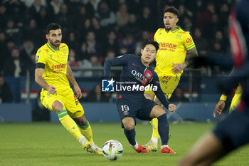 2023-12-09 - Lee Kang-in of PSG between Eray Comert and Douglas Augusto of Nantes during the French championship Ligue 1 football match between Paris Saint-Germain and FC Nantes on December 9, 2023 at Parc des Princes stadium in Paris, France - FOOTBALL - FRENCH CHAMP - PARIS SG V NANTES - FRENCH LIGUE 1 - SOCCER